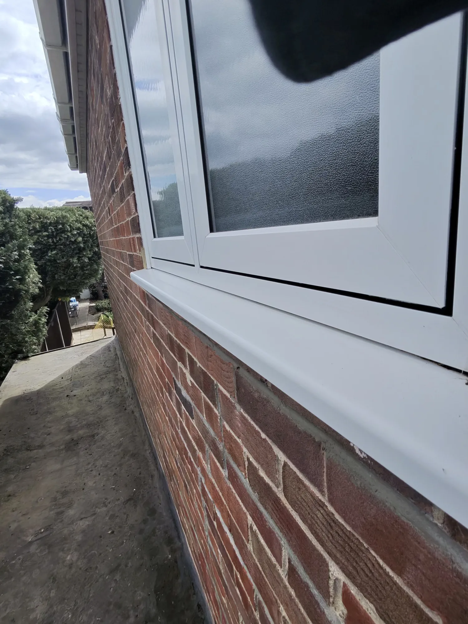Cleaned white uPVC window frame and sill on a brick home in Rickmansworth