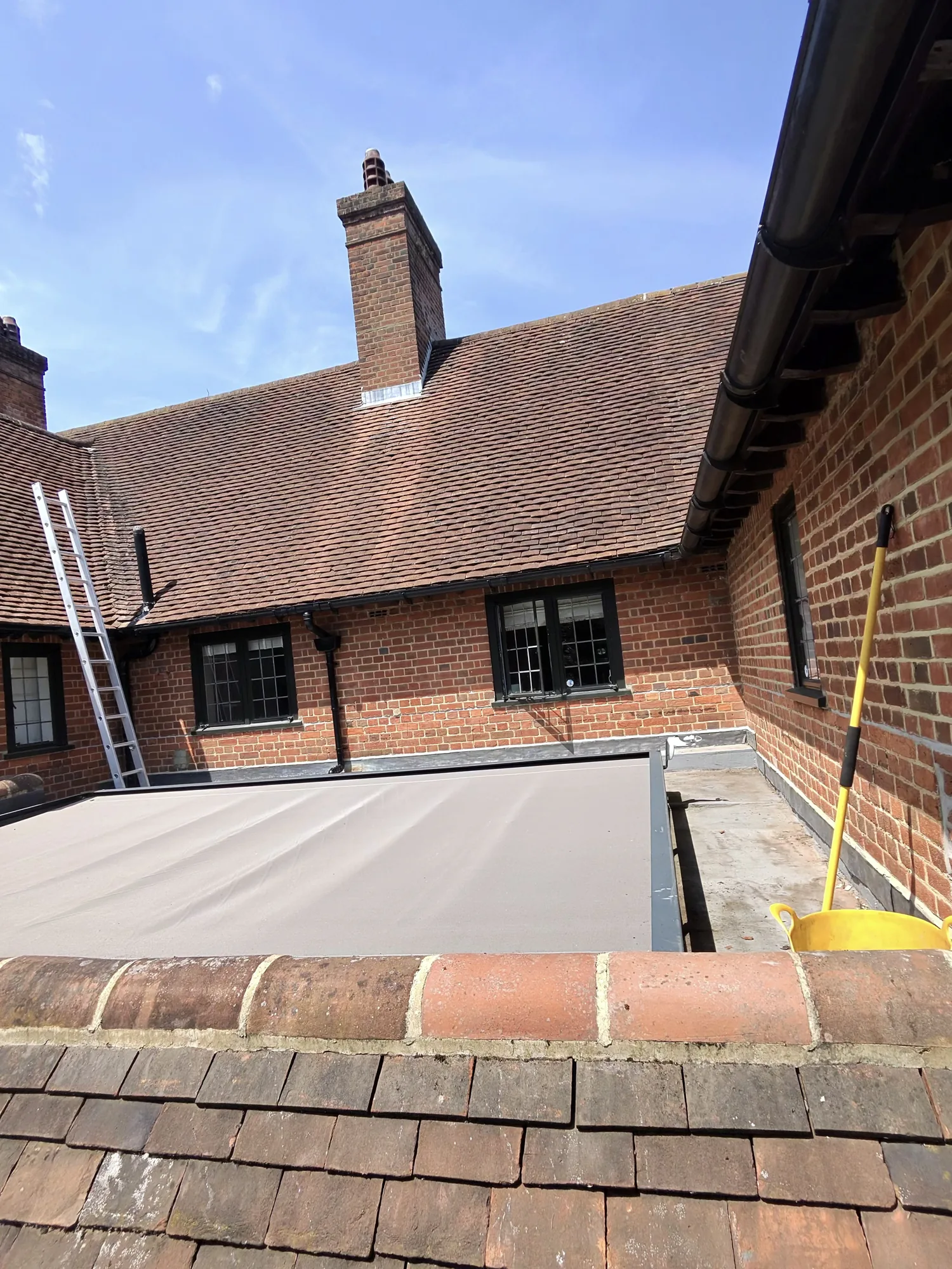 Roof cleaning in progress on a tiled roof in Hertfordshire