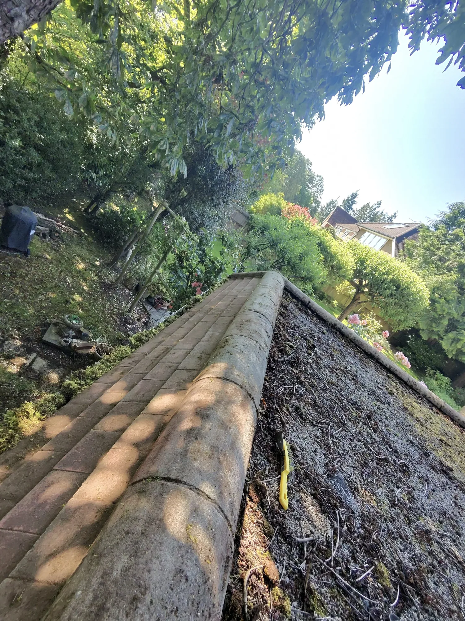 Before and after moss removal on a tiled roof in Hertfordshire