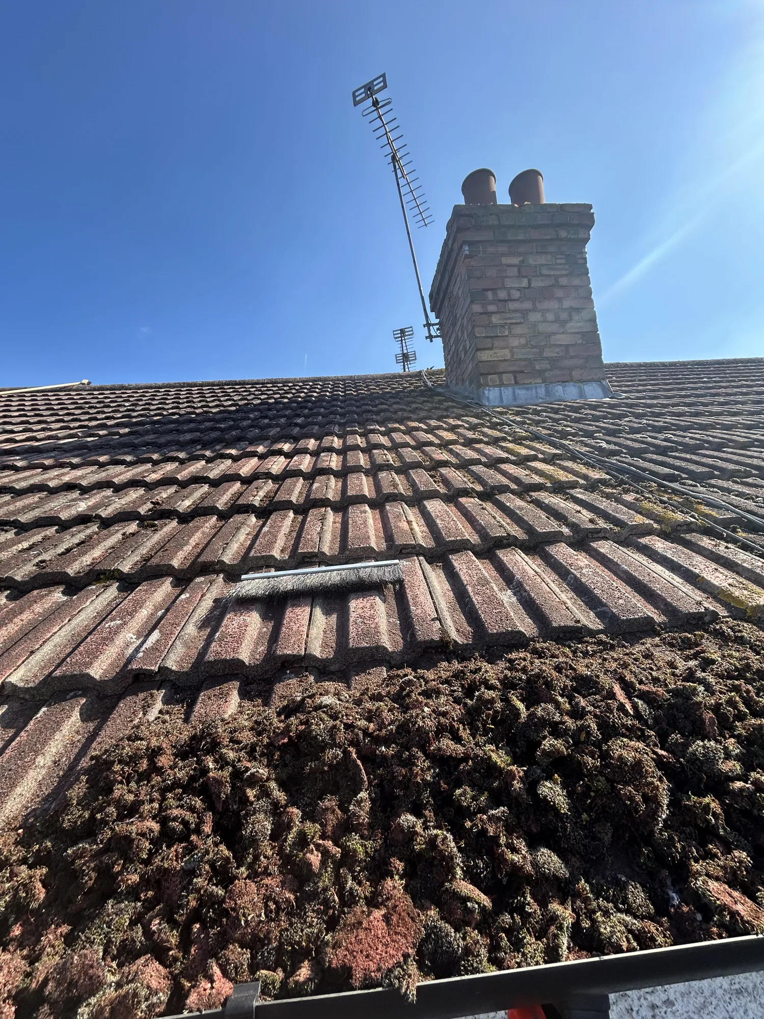 Soft washing a moss covered tiled roof in Hertfordshire